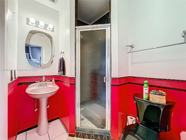 bathroom with walk in shower and tile patterned flooring