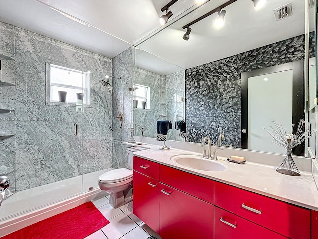 bathroom with vanity, toilet, track lighting, walk in shower, and tile patterned flooring