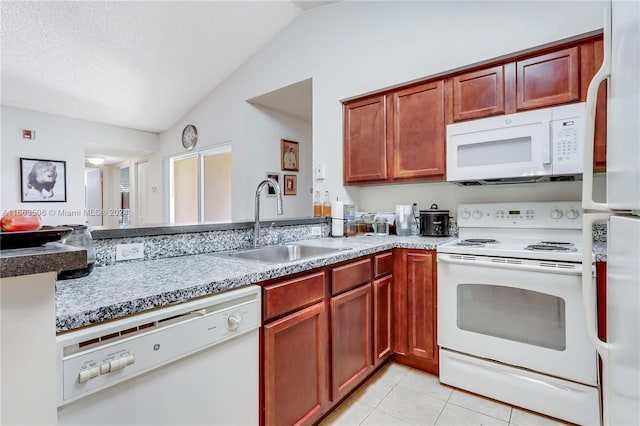 kitchen featuring light tile patterned floors, sink, vaulted ceiling, and white appliances