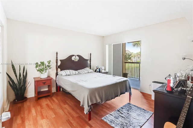 bedroom with hardwood / wood-style flooring and access to exterior