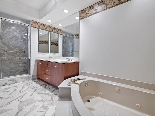 bathroom with vanity and shower with separate bathtub