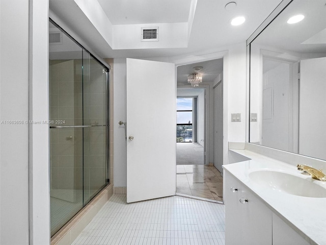 bathroom featuring vanity, tile patterned floors, and an enclosed shower