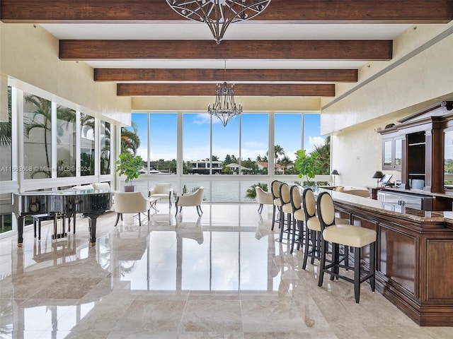 dining room featuring a chandelier and beamed ceiling