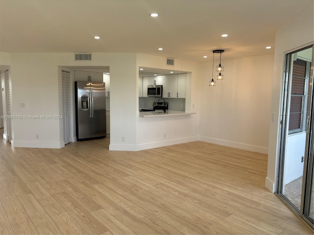 unfurnished living room with light wood-type flooring