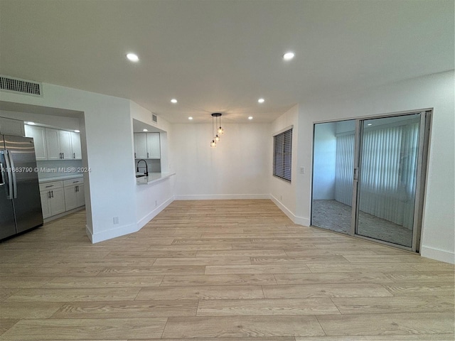 unfurnished living room featuring light hardwood / wood-style floors