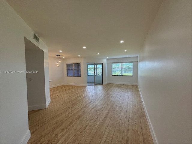 kitchen featuring white cabinets, pendant lighting, light hardwood / wood-style floors, and sink