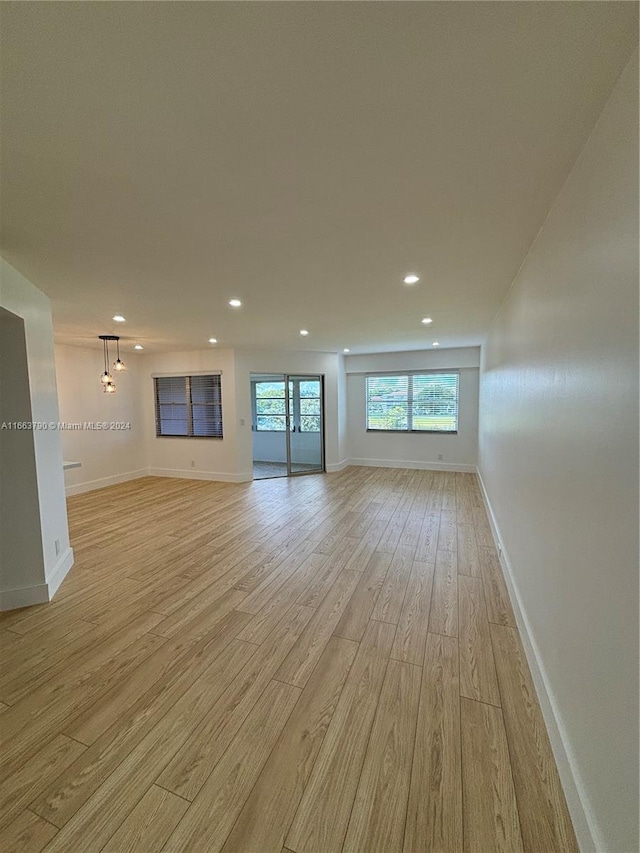 kitchen featuring white cabinetry, light hardwood / wood-style flooring, and appliances with stainless steel finishes