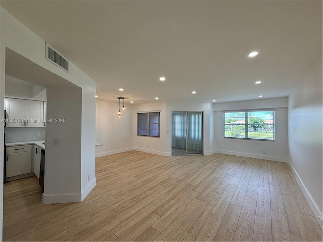 unfurnished living room featuring light hardwood / wood-style floors