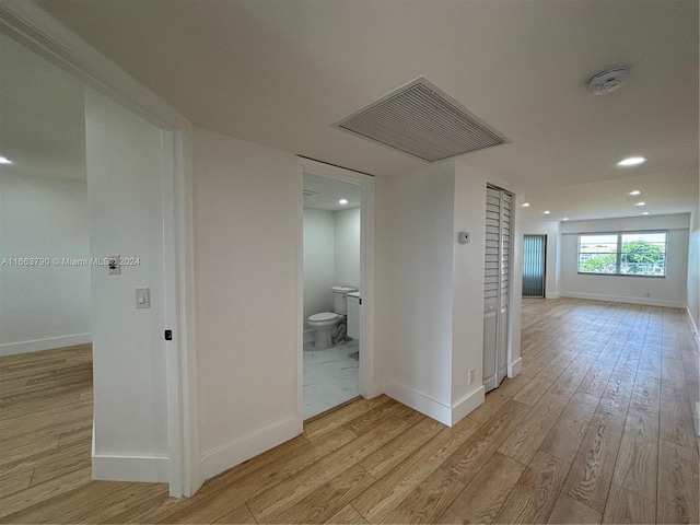 corridor with light wood-type flooring