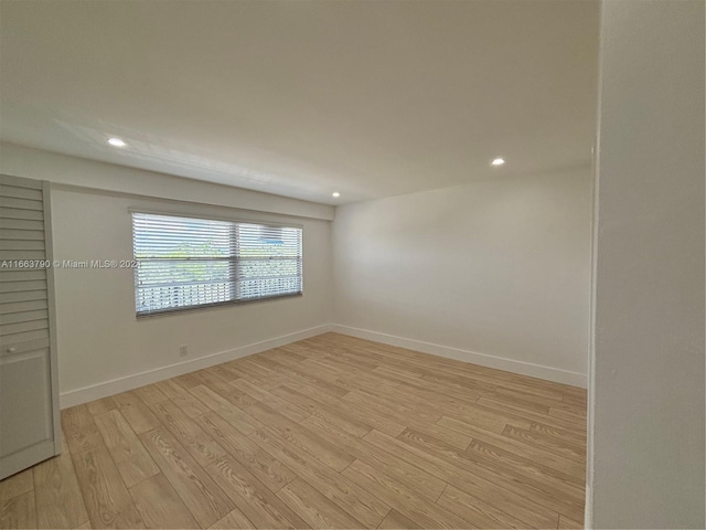 empty room with light hardwood / wood-style flooring