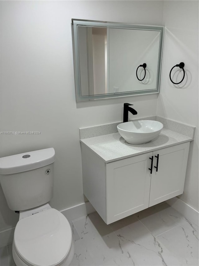 bathroom with vanity and toilet