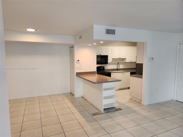 kitchen featuring black appliances, white cabinets, sink, light tile patterned floors, and kitchen peninsula