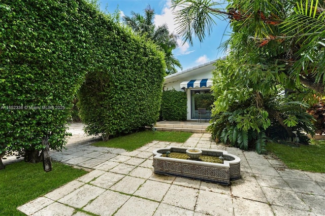 view of yard featuring central AC and a patio