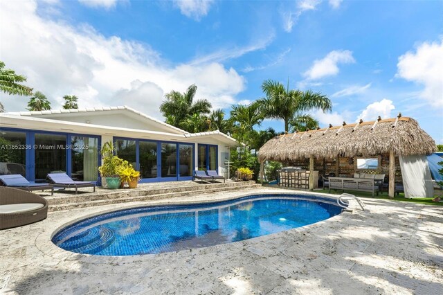 view of swimming pool featuring exterior bar and a patio