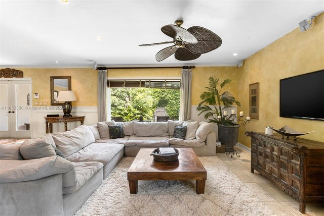 tiled living room with french doors and ceiling fan