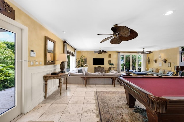 playroom with a healthy amount of sunlight, light tile patterned floors, and ceiling fan