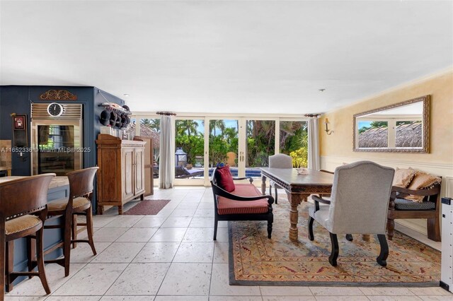 dining area featuring a wall of windows and light tile patterned floors