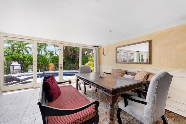 tiled dining room with a healthy amount of sunlight and french doors