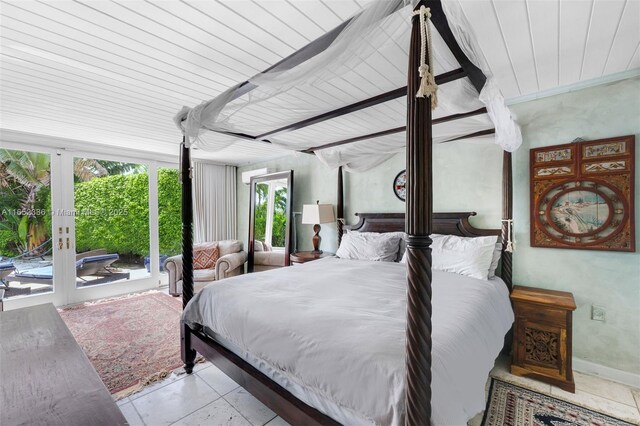 bedroom featuring light tile patterned floors, access to exterior, and french doors