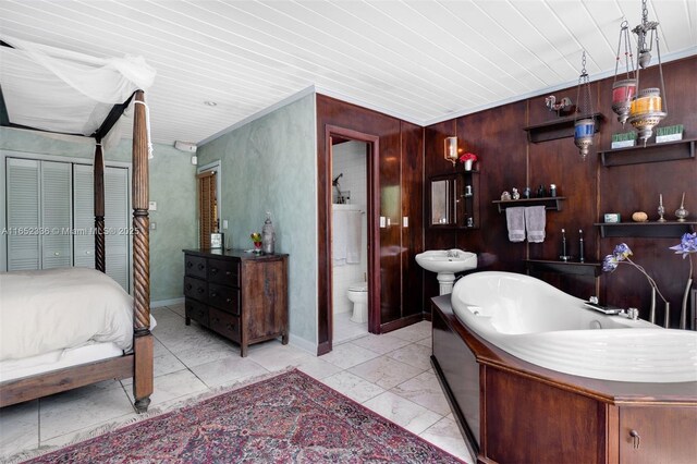 bathroom with a tub to relax in, wood ceiling, wooden walls, and toilet