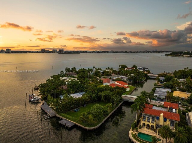 aerial view at dusk with a water view