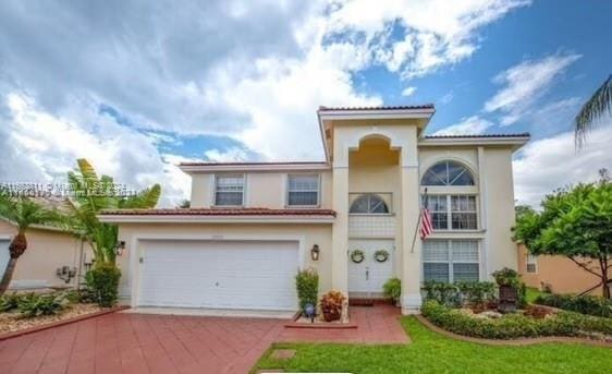 mediterranean / spanish-style home featuring a garage