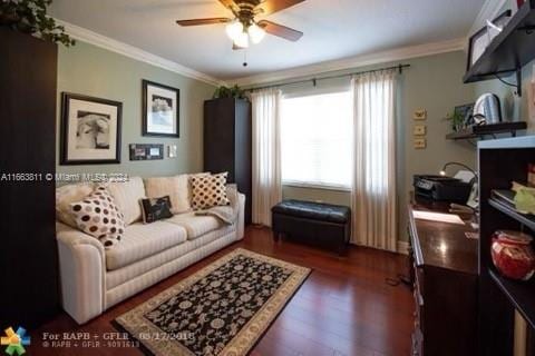 living room with ornamental molding, dark hardwood / wood-style floors, and ceiling fan