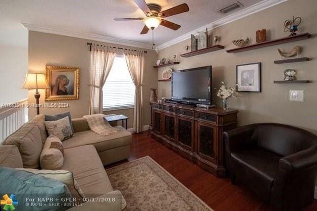 living room with crown molding, dark hardwood / wood-style floors, and ceiling fan