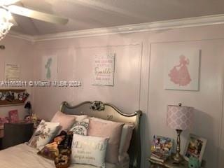 bedroom featuring ceiling fan and crown molding