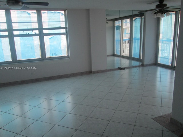 tiled empty room with ceiling fan