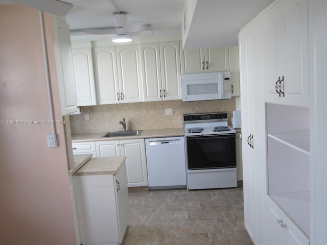 kitchen featuring white cabinetry, tasteful backsplash, sink, and white appliances