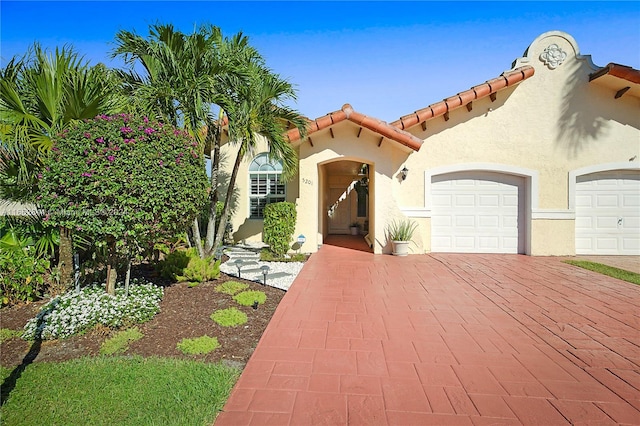 mediterranean / spanish home featuring a garage