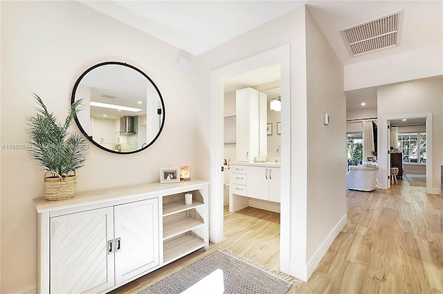 hallway with light hardwood / wood-style flooring