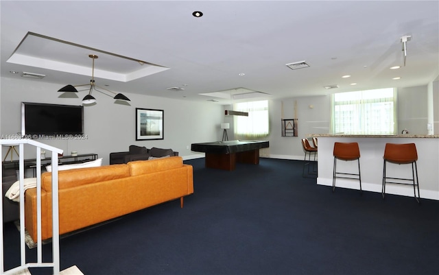 living room featuring a raised ceiling