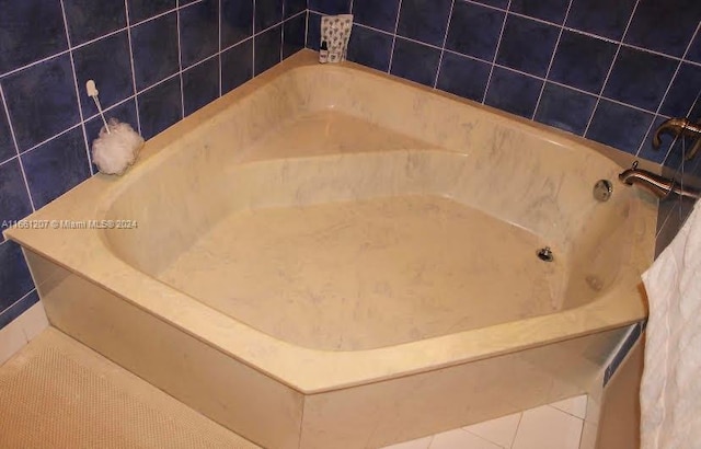 bathroom featuring a washtub and tile patterned floors