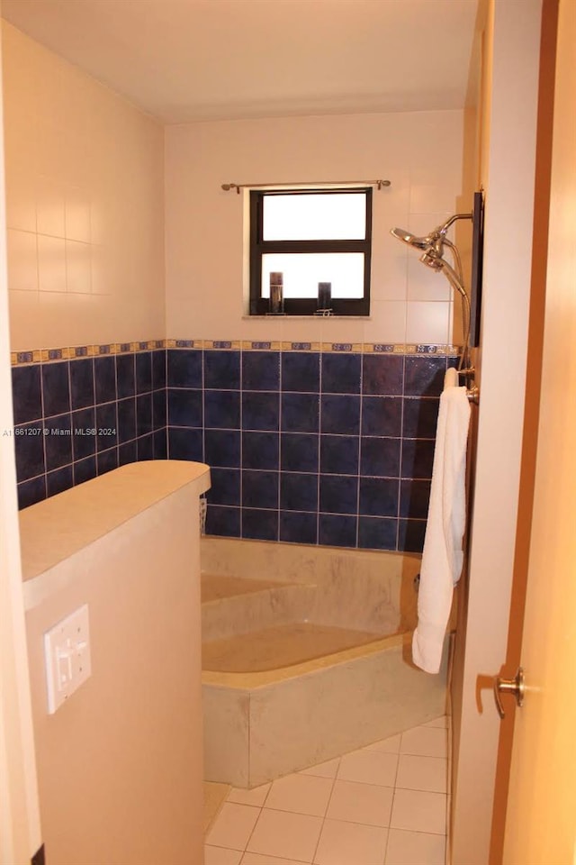 bathroom featuring a bathing tub, tile walls, and tile patterned floors