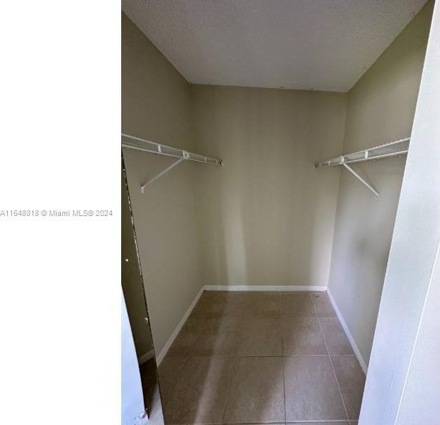 walk in closet featuring tile patterned flooring