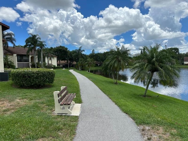 view of home's community featuring a water view and a yard