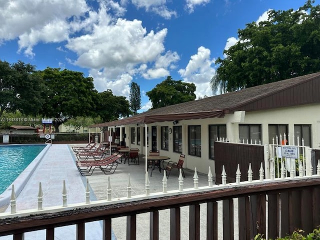 exterior space with a community pool and a patio