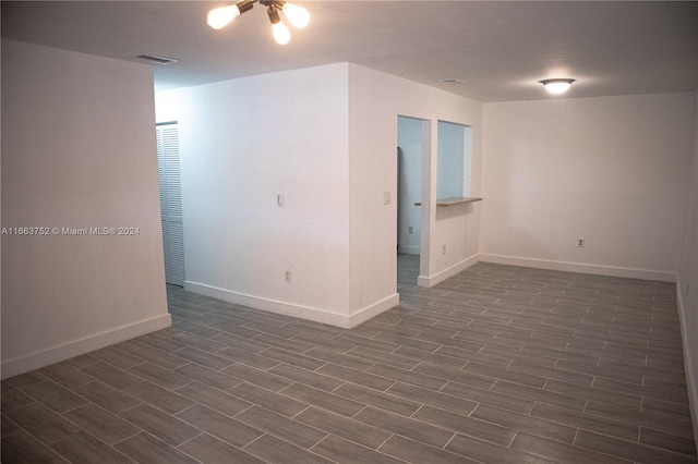 spare room featuring ceiling fan and dark hardwood / wood-style floors