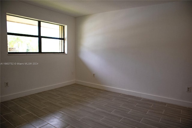 spare room featuring dark wood-type flooring