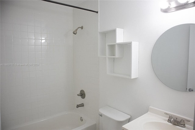 full bathroom with vanity, tiled shower / bath, and toilet