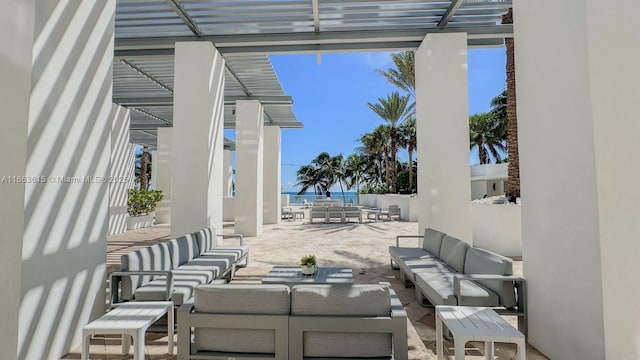 view of patio / terrace featuring an outdoor hangout area, a water view, and a pergola