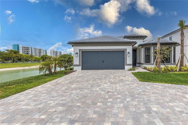 view of front of house with a front yard and a garage