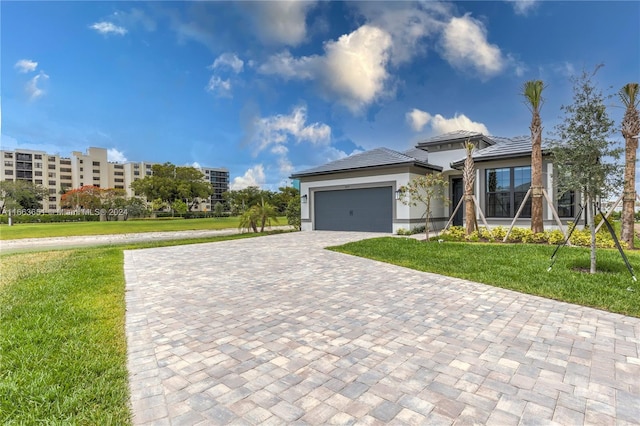 view of front of home with a front yard and a garage