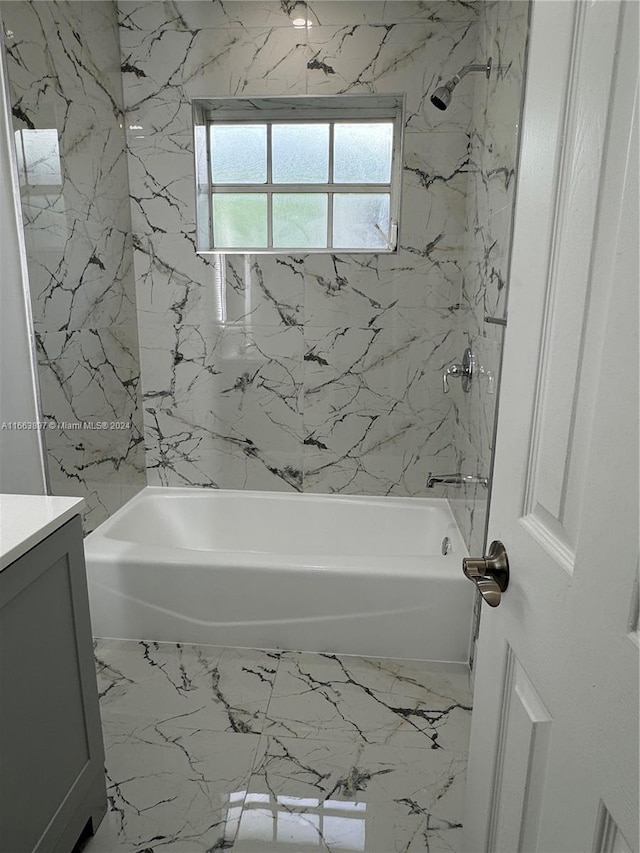 bathroom with vanity and tiled shower / bath combo