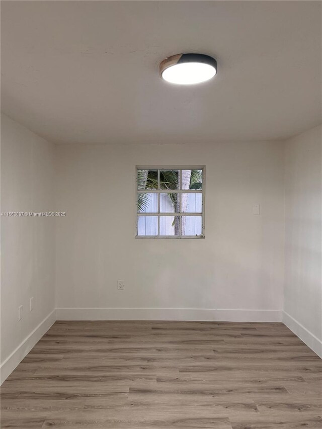 empty room with light hardwood / wood-style flooring