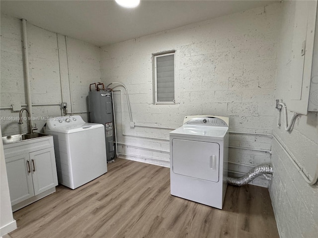 washroom with electric panel, sink, washer and dryer, water heater, and light hardwood / wood-style floors