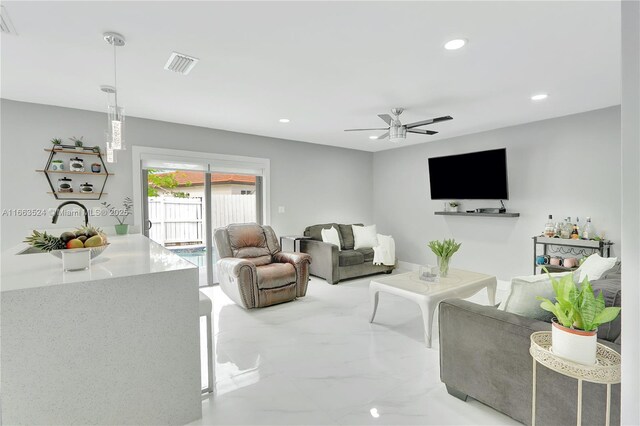 living room with sink and ceiling fan