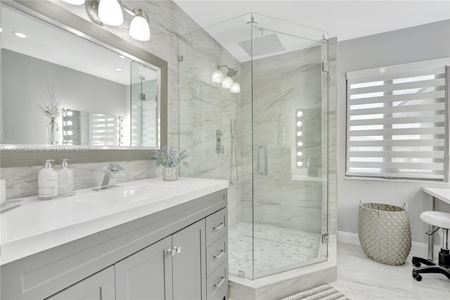 bathroom featuring vanity, a wealth of natural light, and walk in shower